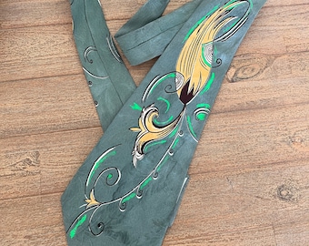 May include: A green silk tie with a yellow and green floral design. The tie has a swirl pattern.
