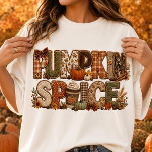 May include: A white t-shirt featuring the text PUMPKIN SPICE in large, textured letters. The letters are filled with various autumn-themed patterns including plaid, knit, and floral designs, accented with small pumpkins, coffee cups, and leaves.