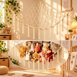 May include: A cream-colored macrame toy hammock featuring a diamond-shaped knotted net design with decorative fringe tassels hanging along the bottom edge, suspended in a corner to store various plush stuffed animals.