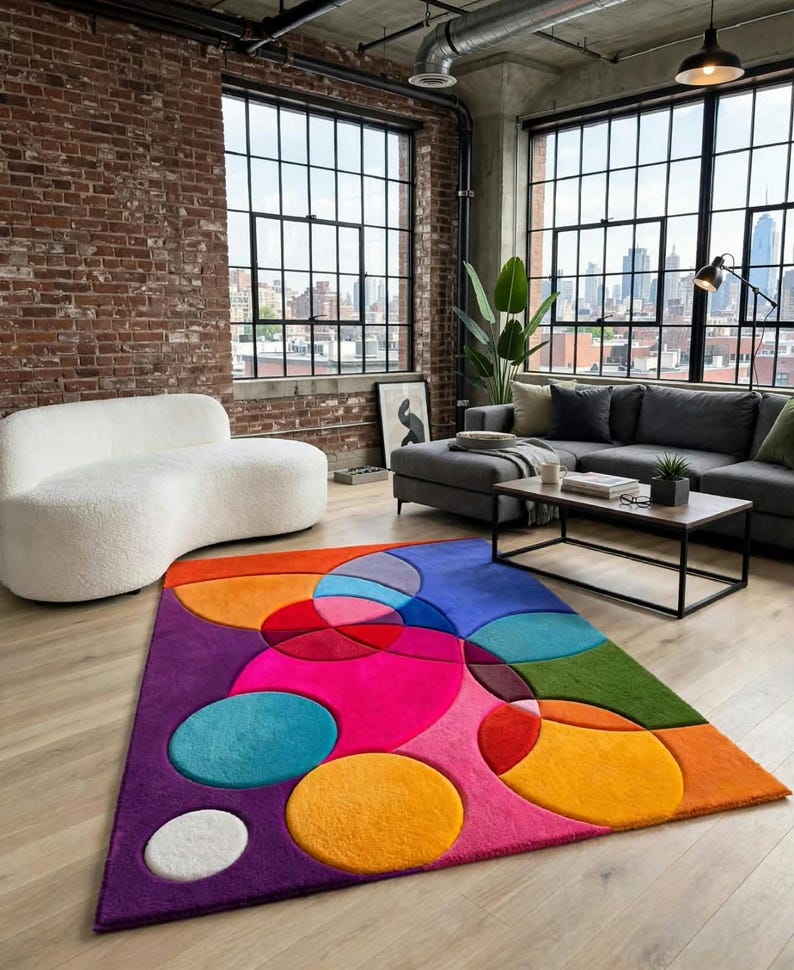 May include: A rectangular area rug featuring a vibrant, multi-colored geometric pattern of overlapping circles and semi-circles in shades of hot pink, orange, purple, teal, green, and white, with a soft, plush texture covering the floor surface.