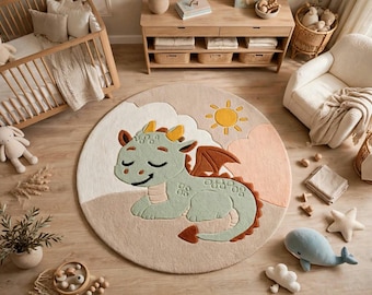 May include: A round area rug featuring a light green dragon with yellow horns and brown wings, resting on a beige background. The design includes a yellow sun and soft pink clouds, with a textured surface and a clean, circular border edge.