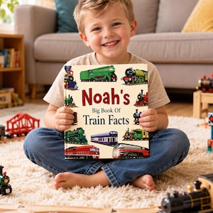May include: A hardcover book titled Noah's Big Book Of Train Facts with a cream-colored cover featuring various colorful illustrations of steam and diesel locomotives and passenger train cars arranged around the central dark red and black text.