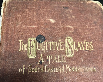 May include: The cover of a brown leather-bound book titled "The Fugitive Slaves A Tale of South Eastern Pennsylvania".