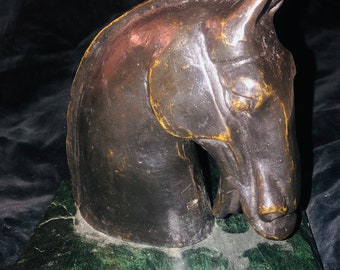 May include: A bronze horse head sculpture on a green marble base.