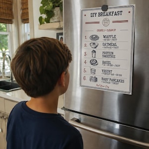 May include: A white rectangular sign with black text and illustrations titled DIY BREAKFAST, listing six meal options including waffle, oatmeal, protein smoothie, bagel, yogurt, and baby pancakes, attached to a stainless steel refrigerator.