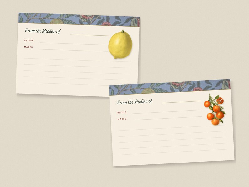 May include: Two cream-colored recipe cards featuring a blue floral border at the top. Each card includes the printed text From the kitchen of, Recipe, and Makes, with lines for writing. One card displays a yellow lemon, the other a cluster of oranges.