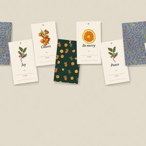 May include: A collection of rectangular gift tags featuring various designs including holly sprigs, orange slices, and citrus branches. Some tags display the text Cheers, Be merry, Joy, or Peace, with lines for To and From. Two tags feature a blue floral pattern.