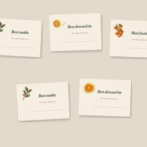 May include: Five off-white rectangular voting cards with black text and botanical illustrations. Two cards read Best cookie with holly, two read Best dressed tin with orange slices, and one reads Most festive with small oranges.