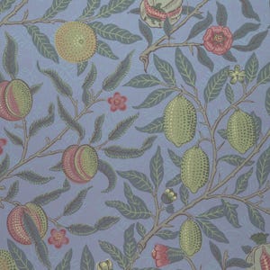 May include: A wallpaper pattern featuring a light blue background with repeating illustrations of green lemons, pink peaches, and small red flowers on brown branches with dark green leaves, creating a dense botanical design.