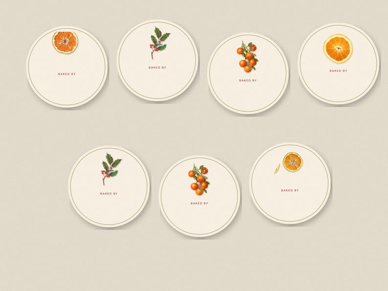 May include: Seven circular cream-colored labels with a thin border. Each label features a small botanical illustration of oranges, orange slices, or holly berries and leaves, with the text "BAKED BY" printed in small brown capital letters.
