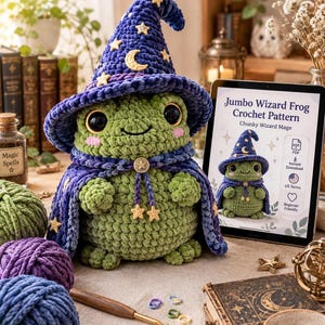 May include: A green crochet frog plush wearing a dark blue wizard hat and cape decorated with yellow stars and a crescent moon. Beside it, a tablet displays the text Jumbo Wizard Frog Crochet Pattern, Chunky Wizard Mage, and PDF.