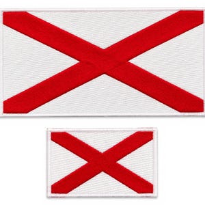 May include: Two rectangular embroidered patches featuring a white background with a bold red saltire cross design. The patches have a clean white border and a textured fabric finish, displaying a clear and symmetrical cross pattern in vibrant red.
