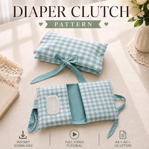 May include: A diaper clutch pattern featuring a light blue and white gingham fabric. The clutch is shown folded and tied with a ribbon, and open with a wipe dispenser slot. Text includes DIAPER CLUTCH PATTERN, INSTANT DOWNLOAD, FULL VIDEO TUTORIAL, and A4 + A0 + US LETTER.