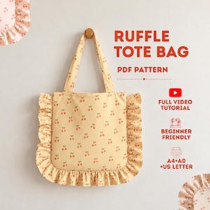 May include: A light yellow tote bag with a repeating red cherry pattern and ruffled edges. The text reads: RUFFLE TOTE BAG, PDF PATTERN, FULL VIDEO TUTORIAL, BEGINNER FRIENDLY, A4+A0+US LETTER. The bag has two shoulder straps and a ruffled trim.