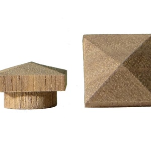 May include: Two wooden pyramid-shaped finials, one with a round base and one with a square base. Both are a light brown color.