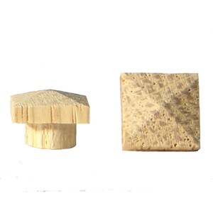 May include: Two wooden finials, one with a square base and a pointed top, and the other with a round base and a pointed top.