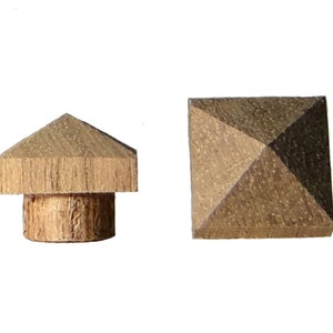 May include: Two wooden pyramid-shaped finials. One finial is a square pyramid and the other is a pointed pyramid with a cylindrical base.