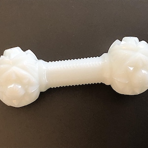 May include: White ceramic dumbbell with a floral design on each end.