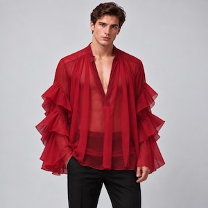 May include: A deep red, sheer, long-sleeved shirt featuring a V-neckline and multiple layers of ruffled fabric along the sleeves. The garment is constructed from a lightweight, translucent material and is paired with solid black trousers.