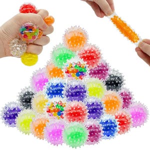 May include: A collection of round, spiky, translucent stress balls filled with colorful water beads in shades of red, orange, yellow, green, blue, purple, and black. Some balls are clear, while others contain multi-colored bead clusters.