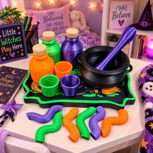 May include: A set of colourful potion-making accessories including a black cauldron with a purple stirring rod, orange and green bottles with wooden stoppers, matching cups, and wavy plastic shapes arranged on a black tray with green trim.