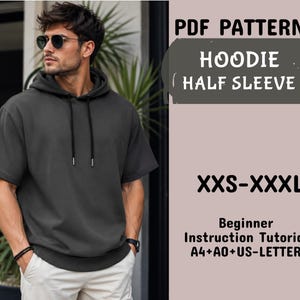 Puede incluir: Una sudadera con capucha de manga corta en color gris oscuro, con cordón en la capucha y dobladillo acanalado. El texto dice: PDF PATTERNS HOODIE HALF SLEEVE XXS-XXXL Beginner Instruction Tutorial A4+A0+US-LETTER. Se lleva con pantalones claros.