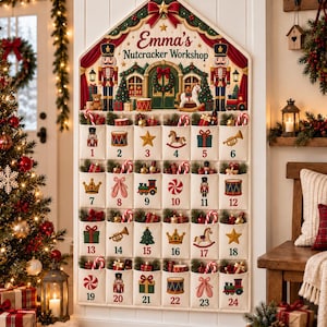 May include: A wall-hanging fabric advent calendar shaped like a house, titled Emma's Nutcracker Workshop. It features twenty-four numbered pockets, each decorated with festive icons like nutcrackers, drums, stars, and trains, filled with small holiday items.