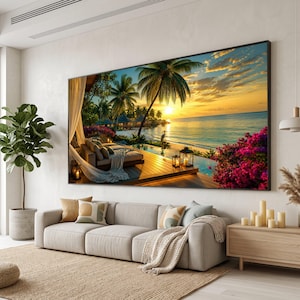 Puede incluir: Un gran cuadro rectangular de pared que muestra una escena de atardecer tropical sobre una playa con palmeras, una terraza de madera, una zona de estar con tela blanca, una piscina infinita y flores de color rosa vibrante.