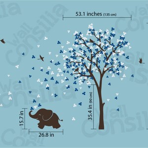 May include: Blue and white tree wall decal with a brown trunk and small blue birds. The tree is surrounded by small blue and white flowers. A brown elephant with a blue trunk is standing below the tree. The decal measures 210 cm tall and 135 cm wide.