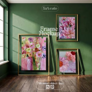 May include: Three gold-colored rectangular frames containing floral artwork, with one large frame on the left and two smaller frames on the right, featuring pink, purple, and yellow flower paintings with the text 3x4 ratio and frame mockup.