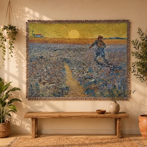May include: A woven tapestry wall hanging featuring a reproduction of Vincent van Gogh's The Sower, depicting a figure sowing seeds in a field under a large yellow sun, with fringed edges and a textured, multi-colored thread construction.