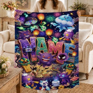 May include: A dark blue fleece blanket featuring a colorful graphic print of various ghost-type creatures, glowing lanterns, and fireworks. The word NAME is printed in large, bold, multi-colored letters across the center of the blanket design.
