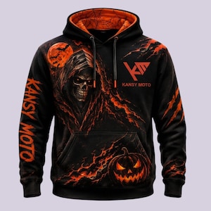 May include: A black hoodie with an orange interior lining featuring a graphic of a hooded skull, a glowing orange moon with bats, and a jack-o'-lantern. The text KANSY MOTO is printed on the chest and down the sleeve in orange lettering.