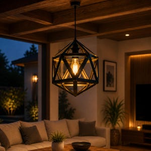 May include: A black geometric pendant light fitting with a cage-like frame made of intersecting metal bars. The fitting hangs from a single cord and contains a single exposed Edison-style light bulb that emits a warm, golden glow.