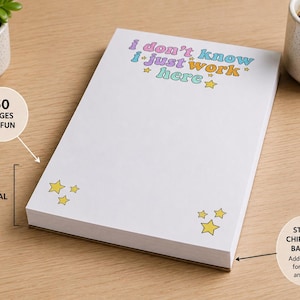 May include: A white rectangular notepad with a sturdy chipboard backing, featuring the text I don't know I just work here in colorful bubble letters at the top, accented by small yellow stars at the top and bottom corners, totaling 50 pages.
