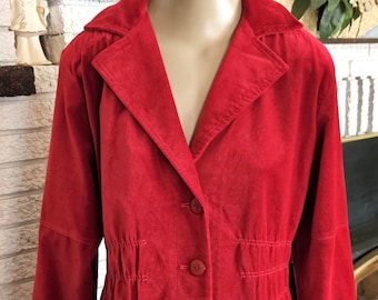 May include: A red, button-down jacket with a notched collar and long sleeves. The jacket has a cinched waist and is displayed on a mannequin. A black skirt is visible below the jacket.