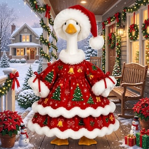 May include: A white goose figurine wearing a red Santa hat with white fur trim and a matching red dress featuring a pattern of green Christmas trees, gold bells, and white snowflakes, finished with white fur trim at the collar and hem.