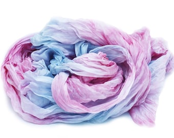 May include: A soft, crinkled fabric scarf in shades of pink and blue. The fabric is gathered and twisted, creating a textured and flowing look.