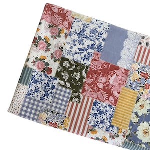 May include: A patchwork fabric featuring a variety of rectangular segments with diverse patterns including pink roses, blue and white floral prints, red and white stripes, blue gingham checks, yellow textures, and white lace-like details.