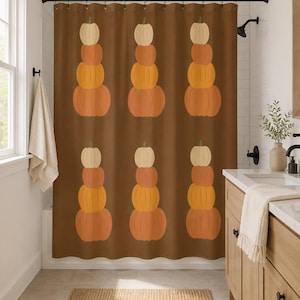 May include: A brown shower curtain featuring a repeating pattern of stacked pumpkins in shades of cream, light orange, and dark orange. The design consists of two rows of three vertical stacks, each containing four pumpkins of varying sizes and colors.