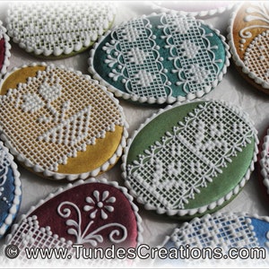 May include: Assortment of oval-shaped cookies decorated with white lace patterns. The cookies are in various colors, including red, blue, green, and gold.