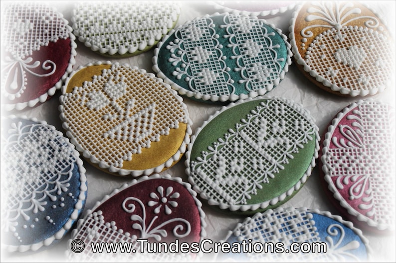 May include: Assortment of oval-shaped cookies decorated with white lace patterns. The cookies are in various colors, including red, blue, green, and gold.