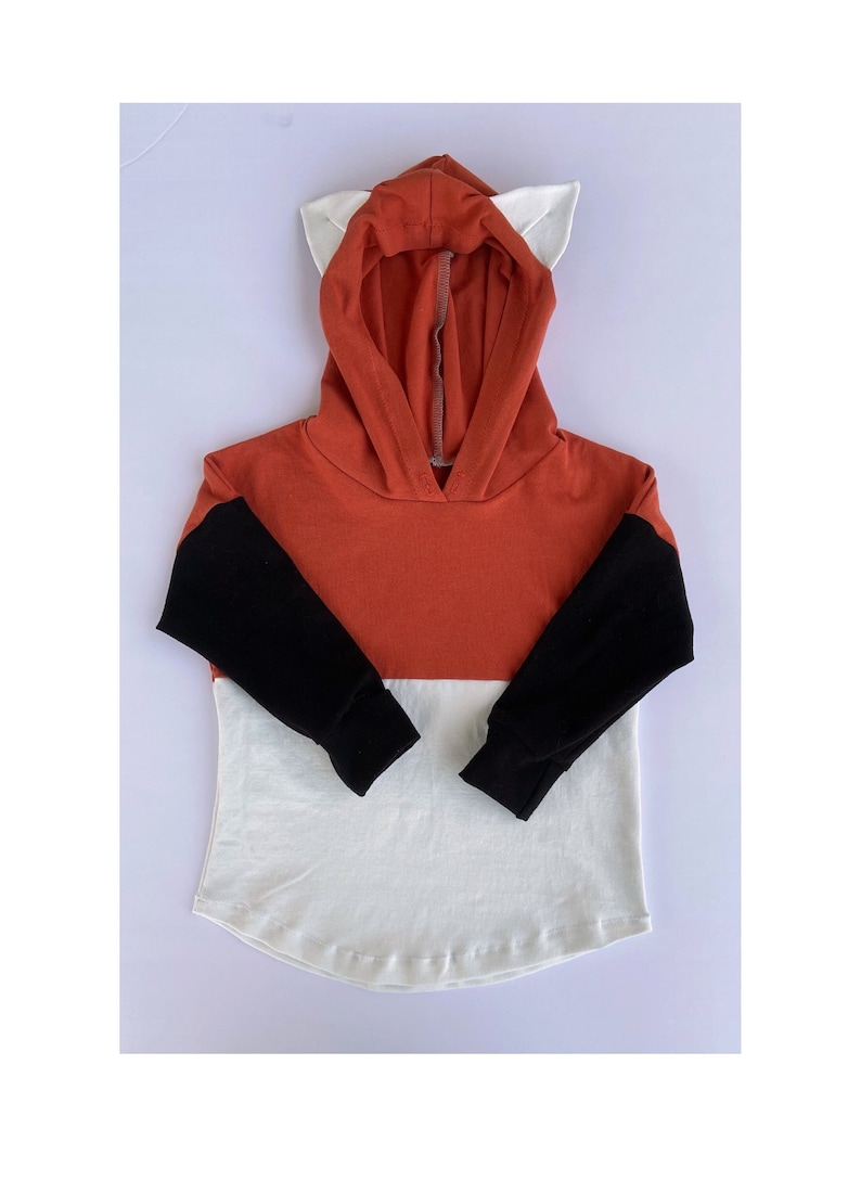 May include: A red, black and white hooded sweatshirt with fox ears on the hood.
