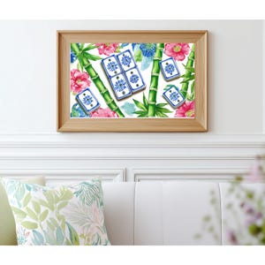 May include: A framed print featuring a watercolor design of bamboo stalks, pink flowers, blue floral accents, and blue and white tiles. The artwork is set against a white background and framed in a light wood frame. The print is mounted on a white wall.