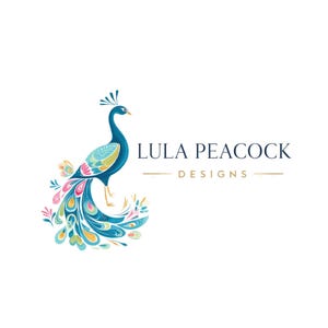 May include: A colorful peacock illustration with a blue body, teal wings, and a vibrant tail featuring pink, yellow, and blue accents. The text "LULA PEACOCK DESIGNS" is displayed in navy blue with gold lines.