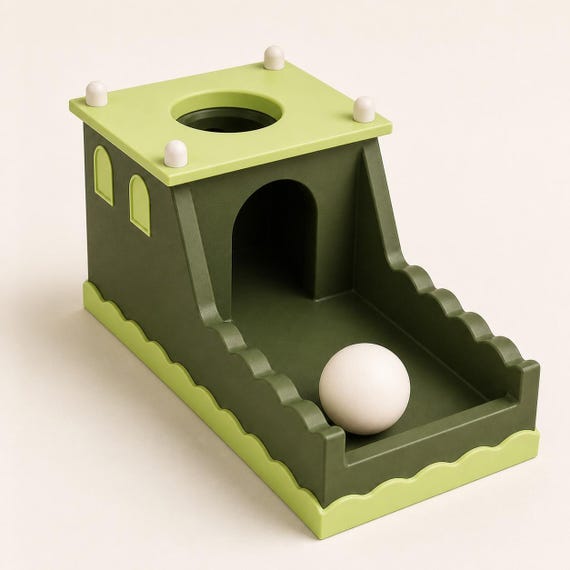 Forest Keep ball drop box in dark green, apple green, and ivory from a close front-right studio view.