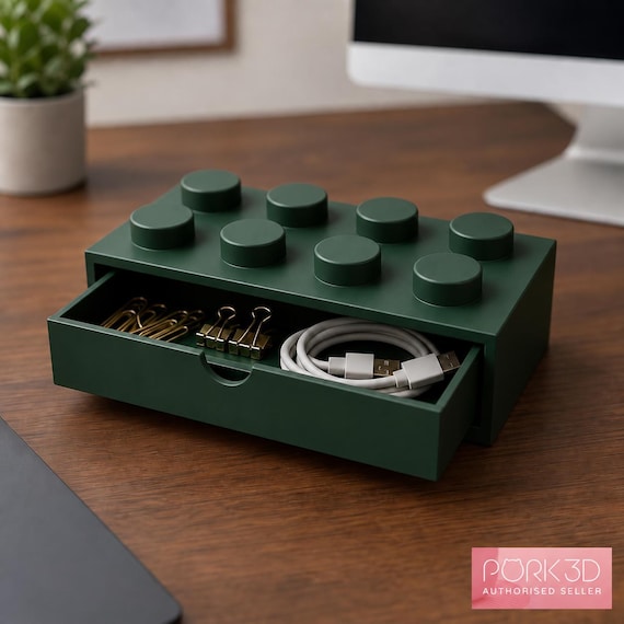 Dark green 4x2 single storage drawer open on a wooden office desk, with a small pink Pork3D authorised seller badge in the lower-right corner.