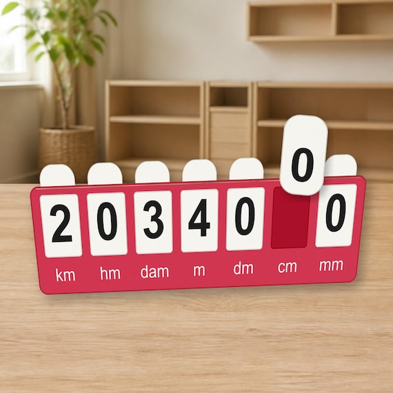 Red length conversion board on a light wood table with one number tab lifted above the open cm position.