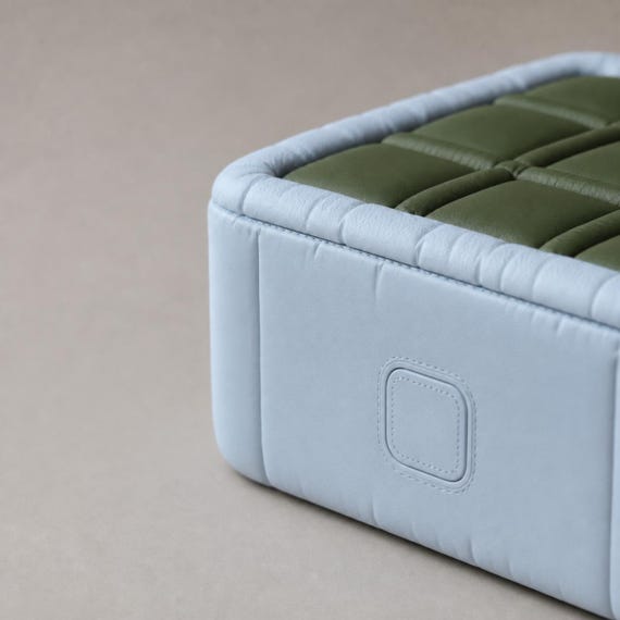 Close-up of the PuffGrid travel game's side release button