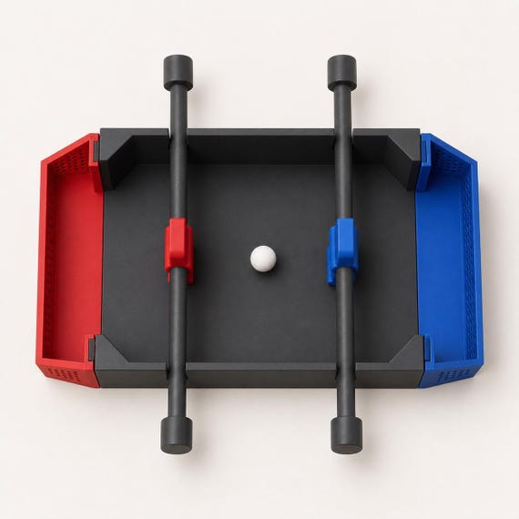Overhead view of the fully assembled Charcoal tabletop soccer game with Scarlet Red and Marine Blue teams and an Ivory White ball